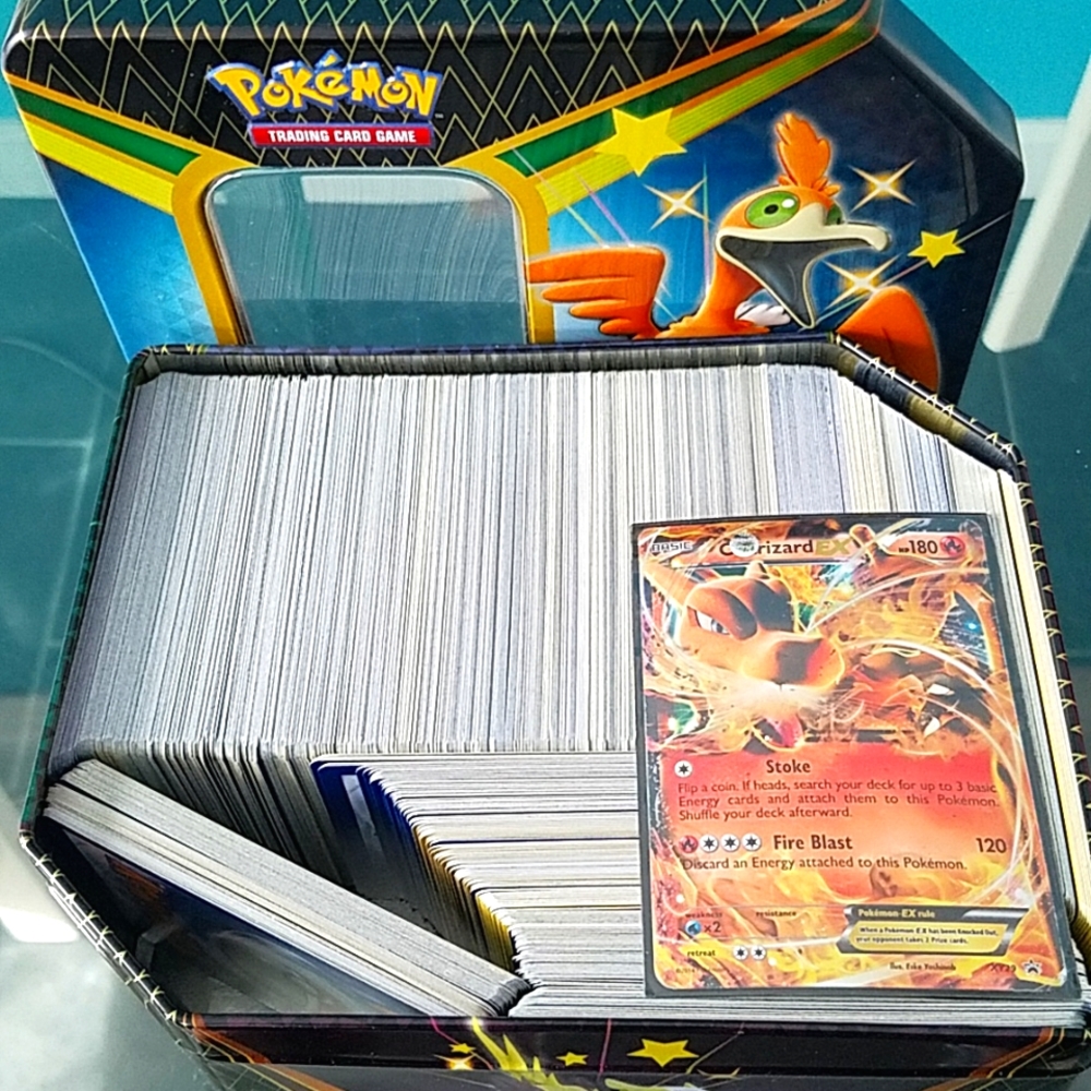 500 Authentic Pokemon tcgs + 1 used charizard card. Includes energy + trainers.